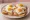 Dubbele Uitsmijter: an illustration of ham, egg and butter on white bread.