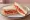 Duke's Mayo Tomato Sandwich: an illustration of mayonnaise, tomato and pepper on white bread.