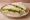 Egg and Watercress: an illustration of egg, mayonnaise, watercress and butter on white bread.