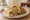 Egg Kathi Roll: an illustration of egg, onion and chutney on naan.