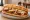 Eggplant Parm Hero: an illustration of eggplant, marinara and mozzarella on hoagie roll.