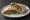 Ejjeh Sandwich (ساندويش عجة): an illustration of egg, parsley, mint and onion on pita.