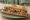 Entrepà de Botifarra amb Mongetes: an illustration of beans on baguette.