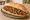 Etsiz Kokoreç: an illustration of oregano, cumin, pepper and tomato on bread.