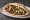 Falafel Batata (פלאפל בטטה): an illustration of chickpeas, tahini, parsley, onion and more on pita.