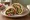 Falafel b'Khubz (فلافل بالخبز): an illustration of chickpeas, tahini, parsley, onion and more on pita.