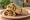 Falafel b'Lafa (פלאפל בלאפה): an illustration of chickpeas, tahini, parsley, tomato and more.