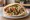 Falafel Ragil (פלאפל רגיל): an illustration of chickpeas, tahini, tomato, cucumber and more on pita.