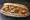 Fat Sandwich: an illustration of beef, chicken, mozzarella and potato on hoagie roll.