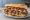 Ferdi Special: an illustration of beef, ham and gravy on baguette.