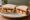 Fish Finger and Ketchup: an illustration of fish, ketchup and butter on white bread.