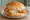 Fish Sandwich (New England): an illustration of fish and tartar sauce on burger bun.
