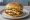 Five Guys Cheeseburger: an illustration of beef and american cheese on burger bun.