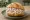 Fleischsalat Brötchen: an illustration of pork, sausage, mayonnaise and pickle on bread.