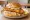 Florida Grouper Sandwich: an illustration of tartar sauce, coleslaw and lemon on burger bun.
