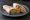 Foul Sandwich (ساندويش فول): an illustration of olive oil, lemon, garlic and cumin on pita.