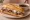 French Dip with Cheese: an illustration of beef, swiss cheese and au jus on hoagie roll.