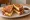 French Toast Sandwich: an illustration of egg, bacon and butter on white bread.