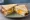Fried Egg Sandwich: an illustration of egg and butter on white bread.
