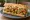 Fried Okra Po' Boy: an illustration of lettuce, tomato and mayonnaise on baguette.