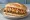 Frita Cubana: an illustration of beef, chorizo, onion and ketchup on cuban bread.