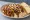 Garbage Plate: an illustration of beef, hot dog, hot sauce, mustard and more on white bread.
