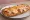 Gerber Sandwich: an illustration of ham, american cheese, garlic, butter and more on baguette.