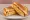 Gilgeori Toast — Pojangmacha Style: an illustration of ham, egg, cabbage, carrot and more on white bread.