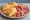 Gnocco Fritto con Salumi: an illustration of prosciutto, mortadella, salami and capicola.
