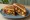 Gobi Manchurian Sandwich: an illustration of onion, garlic, maggi seasoning sauce, pepper and more on white bread.