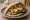 Gourmet Sabich (סביח גורמה): an illustration of egg, eggplant, hummus, tahini and more on pita.