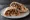Gourmet Shawarma (שווארמה גורמה): an illustration of lamb, tahini, hummus, tomato and more.