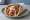 Greek-American Gyro - Chicago: an illustration of beef, lamb, tzatziki, tomato and more on pita.