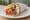 Greek-Australian Souvlaki: an illustration of lamb, chicken, pork, tzatziki and more on pita.