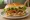 Grilled Chicken Sandwich: an illustration of chicken, lettuce, tomato, pickle and more on burger bun.
