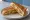 Grilled Sandwich: an illustration of butter, cheese, tomato and chutney on white bread.
