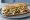 Grinder (New England): an illustration of beef, cheese, lettuce, tomato and more on hoagie roll.