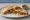 Gringa: an illustration of pork, cheese, onion, cilantro and more on tortilla.
