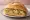 Guajolota de Verde: an illustration of chicken and salsa verde on telera roll.
