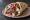 Gyro (American): an illustration of lamb, beef, tomato, onion and more on pita.