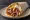 Gyros Athinas (Αθηναϊκός Γύρος): an illustration of pork, chicken, tomato, onion and more on pita.
