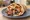 Gyros Hirino Horis Tzatziki: an illustration of pork, tomato, onion and potato on pita.