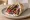 Gyros Moskhari (Γύρος Μοσχάρι): an illustration of beef, tomato, onion and tzatziki on pita.