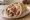 Gyros Pita: an illustration of pork, tomato, onion, tzatziki and more on pita.