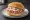 Hackepeter Brötchen: an illustration of pork, onion and pepper on kaiser roll.