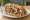 Hähnchen Döner: an illustration of chicken, cabbage, tomato, onion and more.