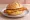 Hähnchenschnitzel Brötchen: an illustration of chicken and butter on kaiser roll.
