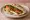 Halloum Meshwi (حلوم مشوي): an illustration of halloumi, tomato and mint on pita.