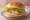 Hamburger Rybny: an illustration of fish, lettuce and tartar sauce on burger bun.