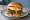 Hamburguesa con Huevo: an illustration of beef, egg, lettuce and tomato on burger bun.